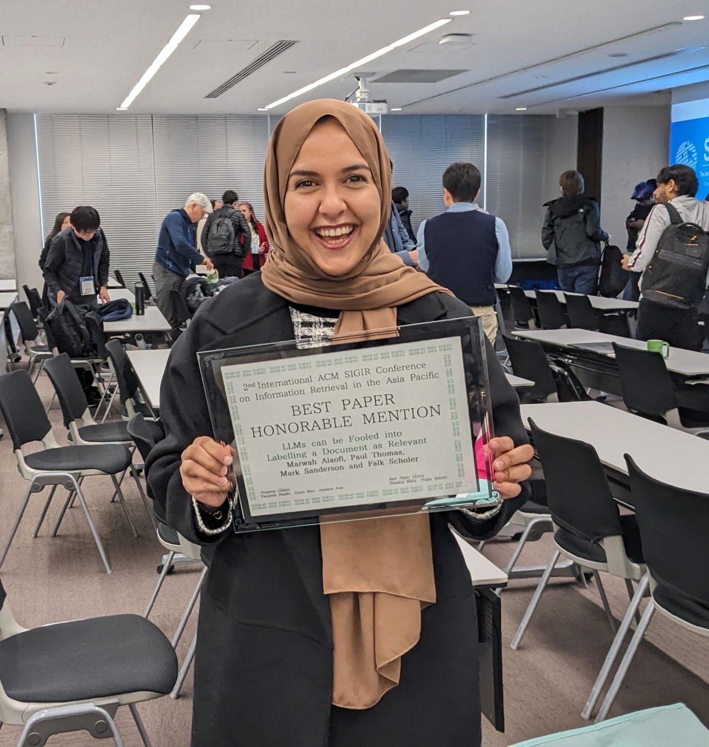 Marwah is showing the Best Paper Honorable Mention award at SIGIR-AP'24